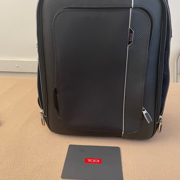 Purchased the Tumi backpack that I’m too old to be carrying one.